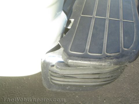 1990 Ford Bronco - Close-up of a chrome rear step bumper with ribbed rubber tread pad at the corner of a vehicle.