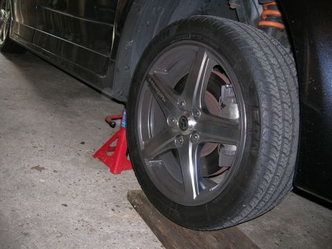 1994 Ford Probe - Car wheel and suspension detail, with the vehicle on a jack stand.