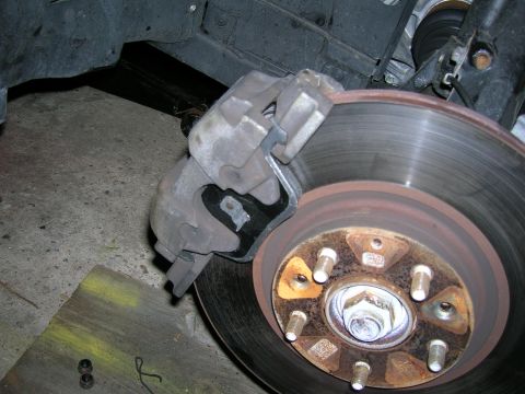1994 Ford Probe - Close-up view of a vehicle's brake caliper and rotor.