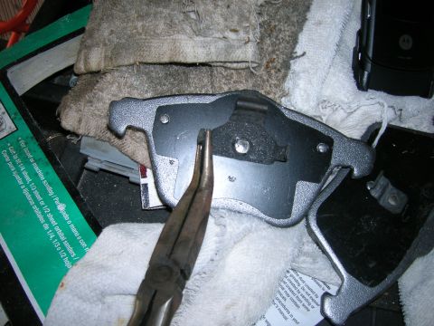 1994 Ford Probe - Tools and brake caliper parts are laid out on a cloth, with a green package of sandpaper visible.