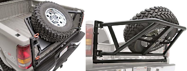 Aftermarket spare tire carrier mounted in a truck bed, with a large off-road tire