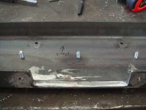 1996 Ford Bronco - A metal bracket with bolts is shown, with handwritten text indicating 'Back'.