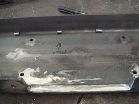 1996 Ford Bronco - A metal component, possibly a winch mount, shows four threaded bolts and handwritten directional text.