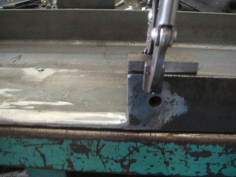1996 Ford Bronco - Close-up of a metal frame being held by a clamp during work.