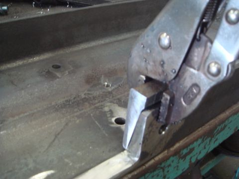 1996 Ford Bronco - Close-up of vise grips securing a metal piece on a work surface.
