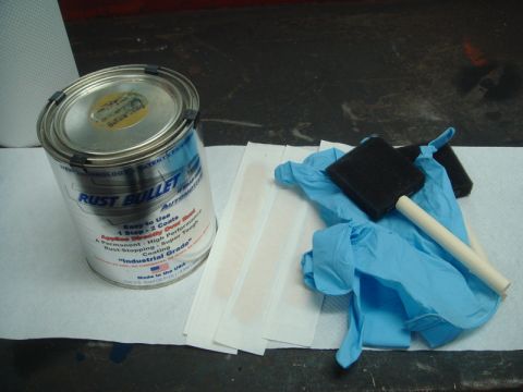 1996 Ford Bronco - Rust Bullet coating supplies including gloves and applicators are laid out on a surface.