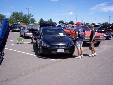 1972 Ford Ranchero - Black Honda Accord on display at a car show with other vehicles in the background.