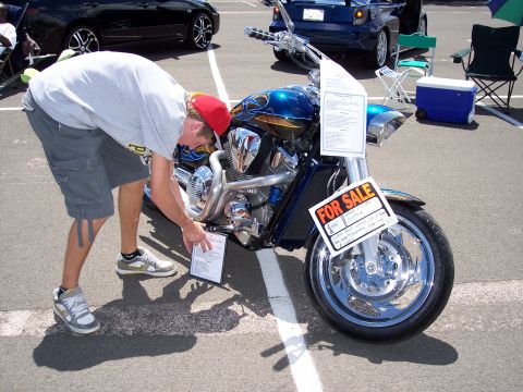 1972 Ford Ranchero - A custom motorcycle with flame graphics is displayed for sale at an outdoor event.