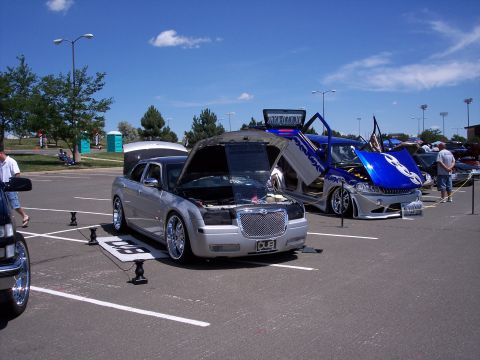 1972 Ford Ranchero - Customized Chrysler 300s displayed with their hoods and doors open at an outdoor event.