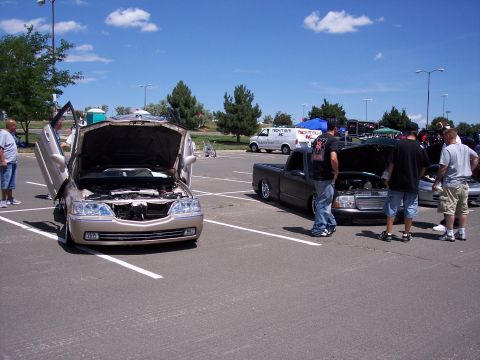 1972 Ford Ranchero - Cars on display at an outdoor event with people gathered around.