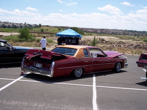 1972 Ford Ranchero - A customized 1977 Cadillac Coupe DeVille is displayed with its hood and trunk open.
