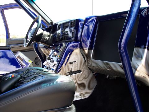 1972 Ford Ranchero - The interior of a heavily modified vehicle features custom paint and entertainment systems.