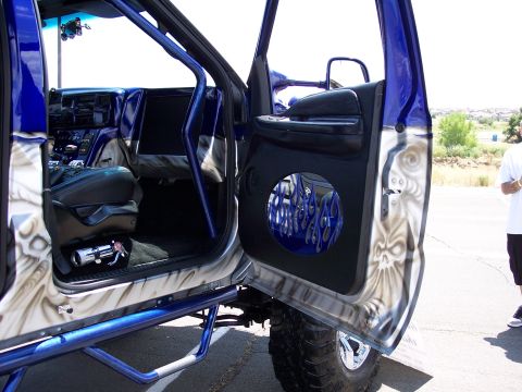 1972 Ford Ranchero - Interior view of a heavily customized truck, a blue roll cage and a speaker grille with a flame design.