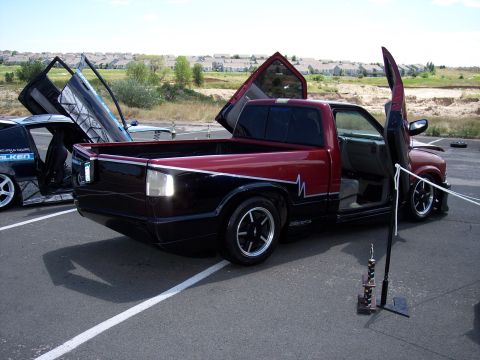 1972 Ford Ranchero - Two modified vehicles with their doors open at an outdoor event.