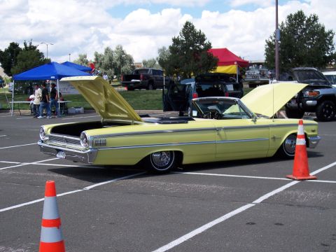 1972 Ford Ranchero - A yellow 1963 Ford Galaxie convertible is displayed with both hoods open at an outdoor event.