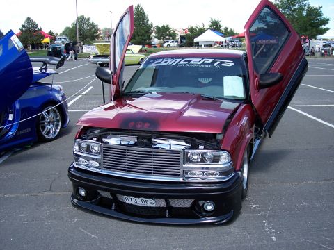 1972 Ford Ranchero - Customized pickup truck with gullwing doors and aftermarket grille at a car show.