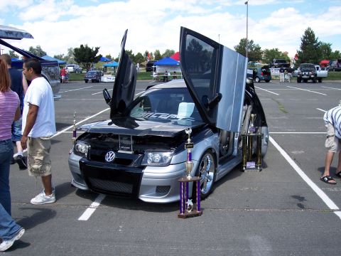 1972 Ford Ranchero - A modified Volkswagen Jetta is displayed with its doors open, surrounded by trophies.