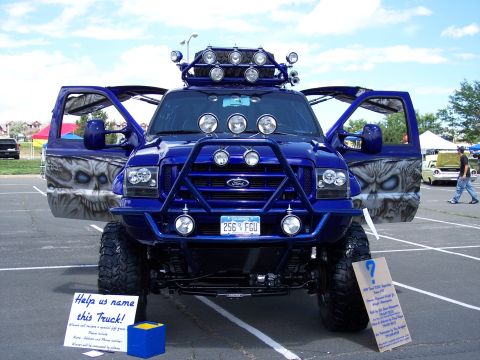 1972 Ford Ranchero - A modified blue Ford truck with custom artwork and accessories is parked outdoors.
