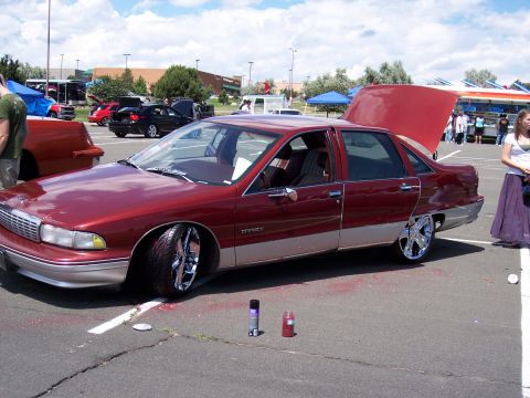 1972 Ford Ranchero - A customized sedan with its hood and trunk open sits in a parking lot.