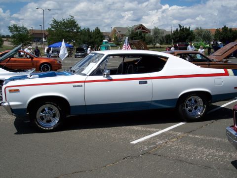 1972 Ford Ranchero - Side view of a white 1970 AMC Gremlin X with red and blue racing stripes.