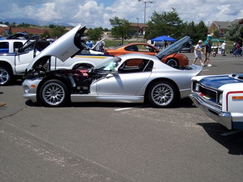 1972 Ford Ranchero - A silver Dodge Viper is displayed with its hood open at an outdoor car show.