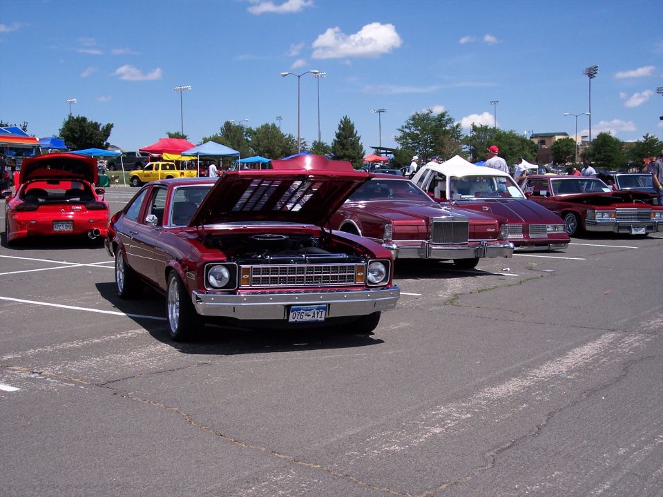 Red coupe with hood open, showing engine. License plate reads OEB-472