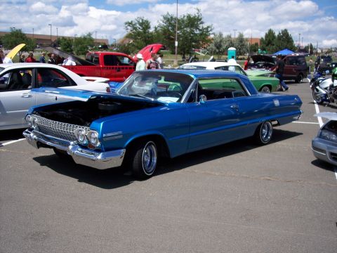 1972 Ford Ranchero - Blue 1963 Chevrolet Impala coupe with hood open, parked at an outdoor car show with other vehicles.