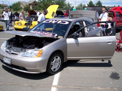 1972 Ford Ranchero - Honda Civic on display at an outdoor car show with hood and door open.