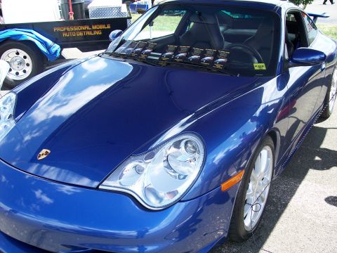 1972 Ford Ranchero - A blue Porsche 911 is parked outside, with a detailing trailer in the background.