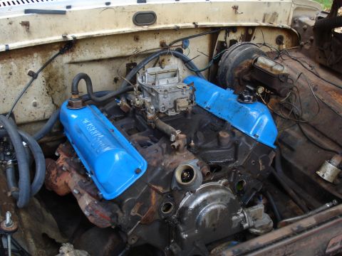 1967 Ford F-250 - Close-up view of an engine bay, showing the carburetor and valve covers.