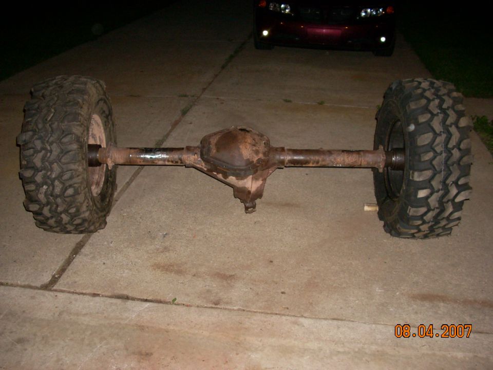 Rear axle assembly with two large off-road tires. Date stamp reads 08.04.2007