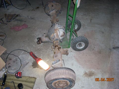 2000 Chevrolet Tahoe - A rear axle assembly is shown on a dolly in a garage setting.