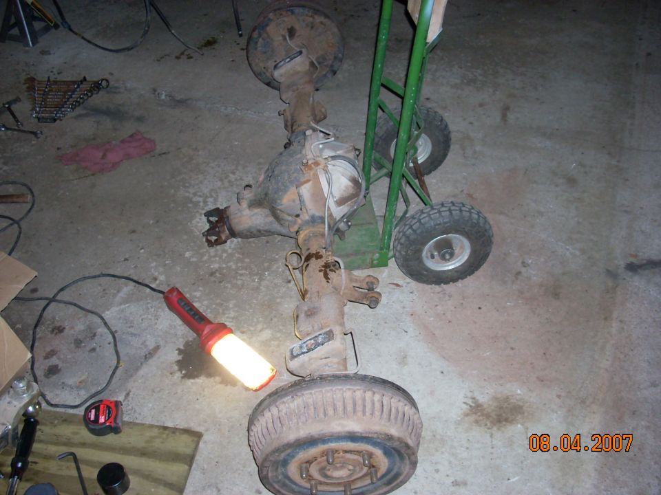 Rear axle assembly on a dolly with a drum brake and a work light illuminating it