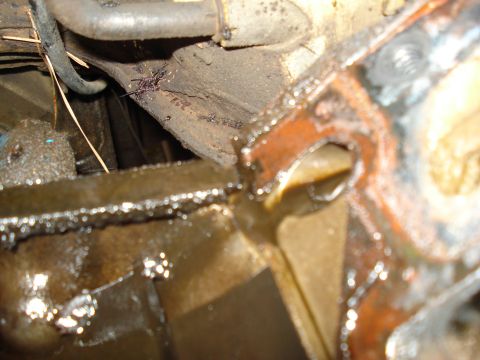 1967 Ford F-250 - A close-up view of an oily engine component, likely part of a larger engine assembly.