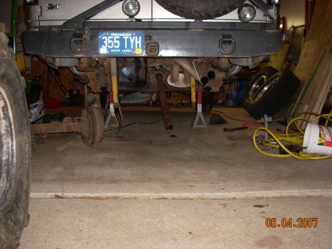 2000 Chevrolet Tahoe - Rear axle and suspension work in progress, with a Michigan license plate on the bumper.