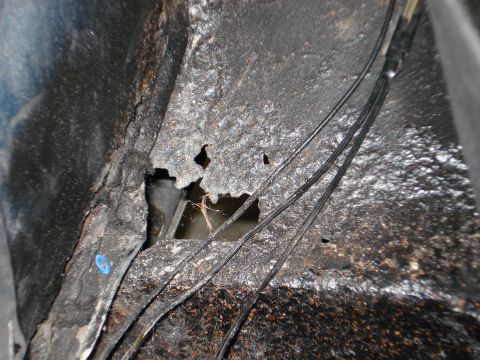 1979 Chevrolet C/K Pickup - Detail of corroded metal and wiring, likely from a vehicle's undercarriage or frame.
