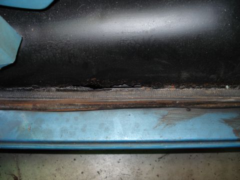 1979 Chevrolet C/K Pickup - Rust damage is visible on the door frame of a 1979 Chevrolet C/K Pickup.