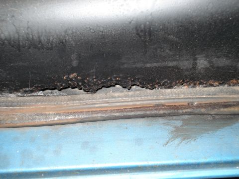 1979 Chevrolet C/K Pickup - This image shows significant rust and corrosion on a vehicle's body panel, indicating potential structural damage.