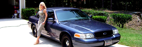 Blue 1998 Ford Crown Victoria with a woman leaning on the driver's side door