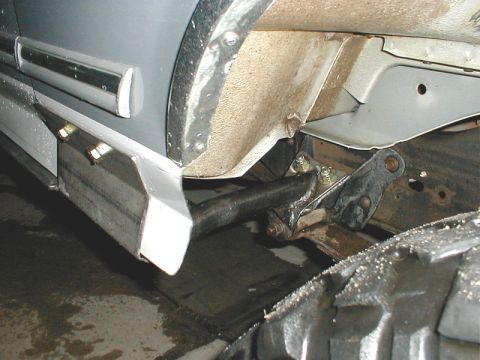 1996 Ford Bronco - Close-up of the side of a 1996 Ford Bronco, highlighting its running boards and suspension.