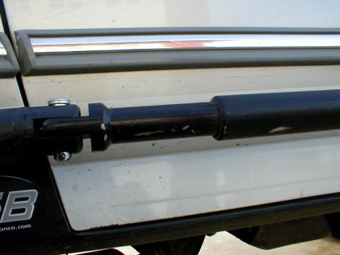 1996 Ford Bronco - Black accessory mounted on the side of a vehicle, near the door trim.