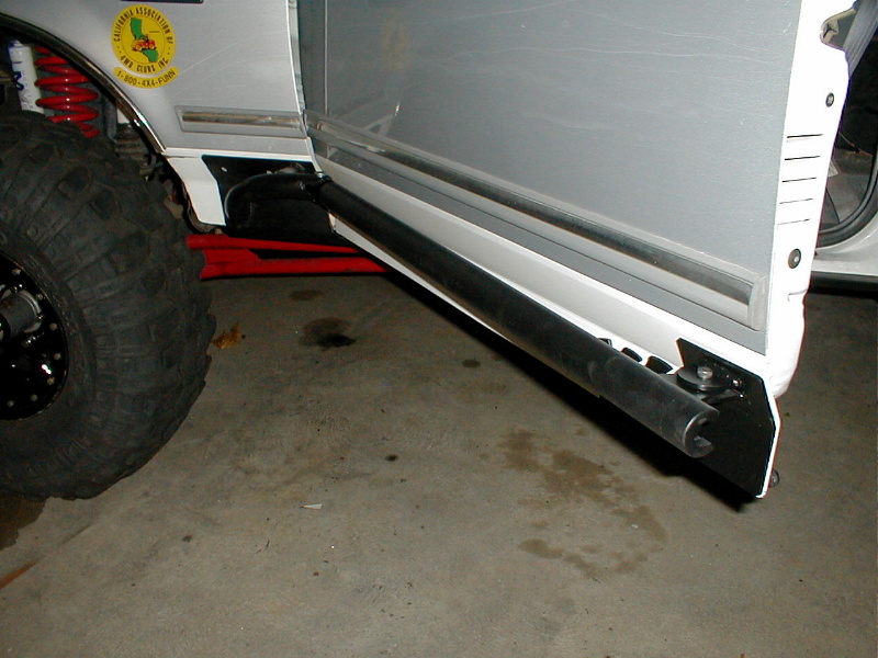 1996 Ford Bronco side view with large tires and aftermarket sliders