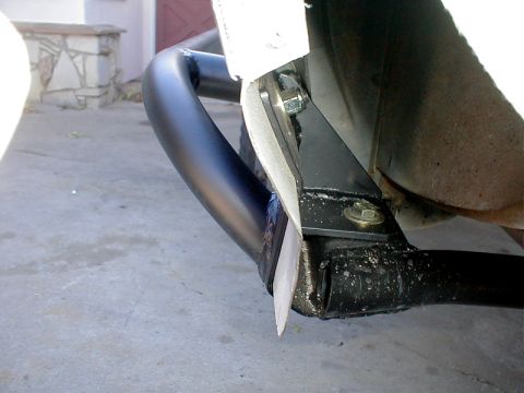 1996 Ford Bronco - Close-up of an aftermarket brush guard mounting bracket on a vehicle frame.