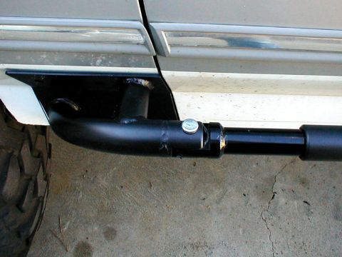 1996 Ford Bronco - An aftermarket rock slider is bolted to the vehicle's frame, providing protection for the lower body panels.