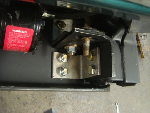 1996 Ford Bronco - Close-up of a winch mount bracket installation, a red warning label with operating instructions.
