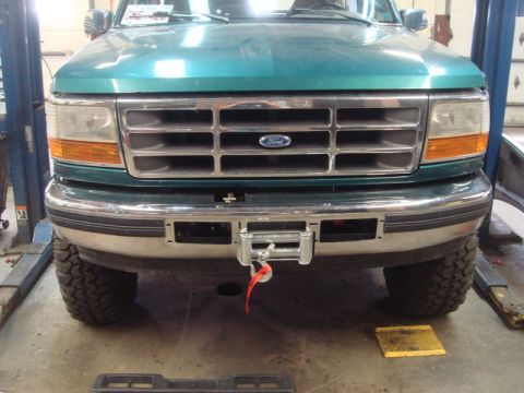 1996 Ford Bronco - A green Ford truck is shown from the front, a newly installed winch on its bumper.