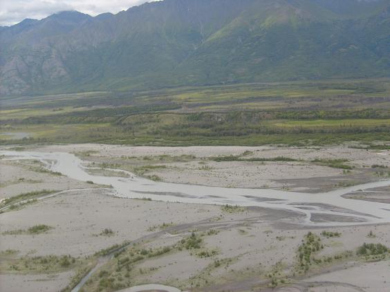 River delta landscape with mountains in background and Supermotors logo