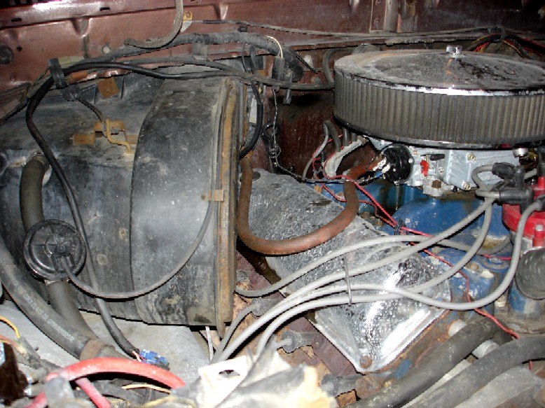 Engine bay with carburetor and air cleaner