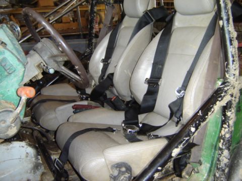 1992 Ford Bronco - Interior view of a modified off-road vehicle, showing seats, harnesses, and roll cage.