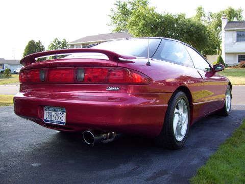 1995 Ford Probe - Rear view of a red 1995 Ford Probe GT, a prominent spoiler and dual exhaust pipes.